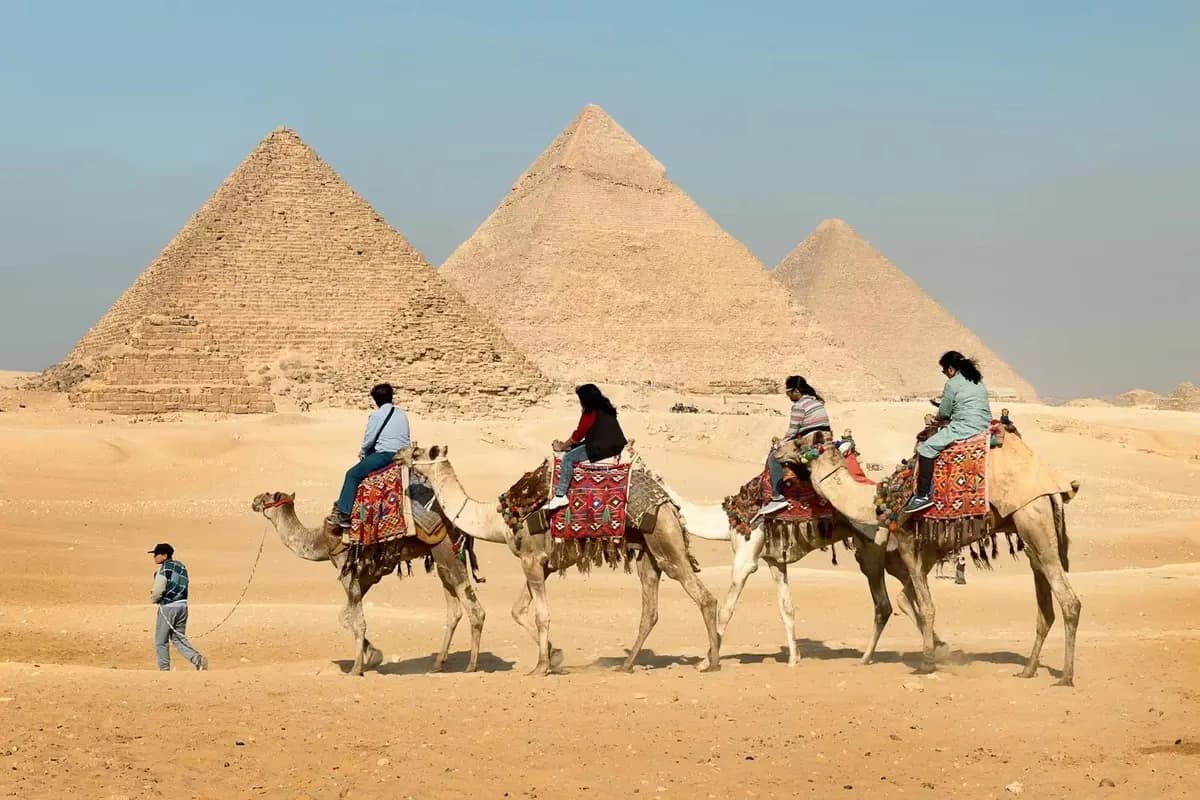 Camel riders beside the pyramids of Giza