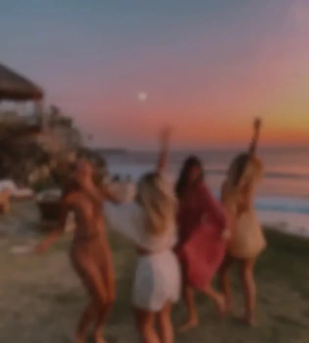 Friends enjoying a sunset by the sea