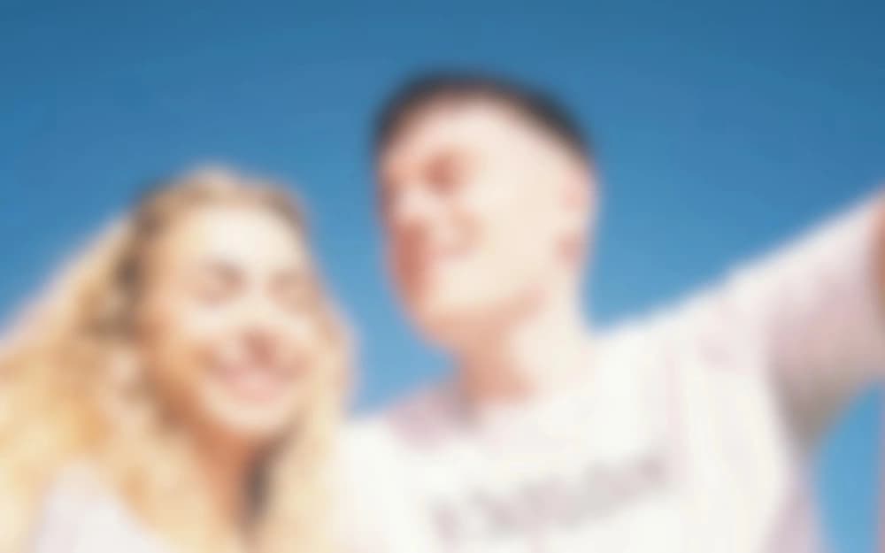 Travellers posing together beneath a blue sky