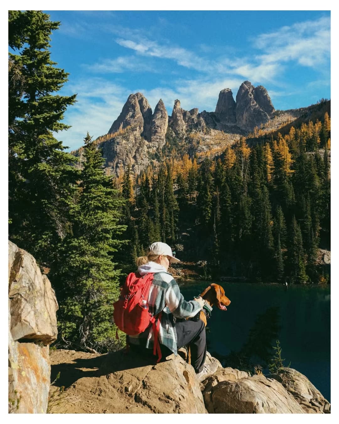 Hikers following a trail beneath mountain peaks