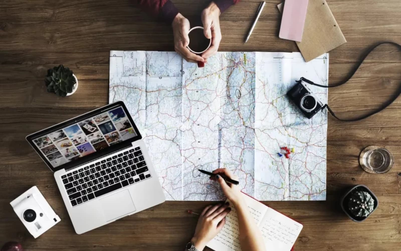 Travellers planning a route with a paper map