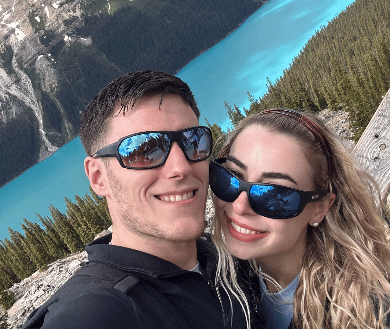 Max and Samantha together beside a turquoise mountain lake