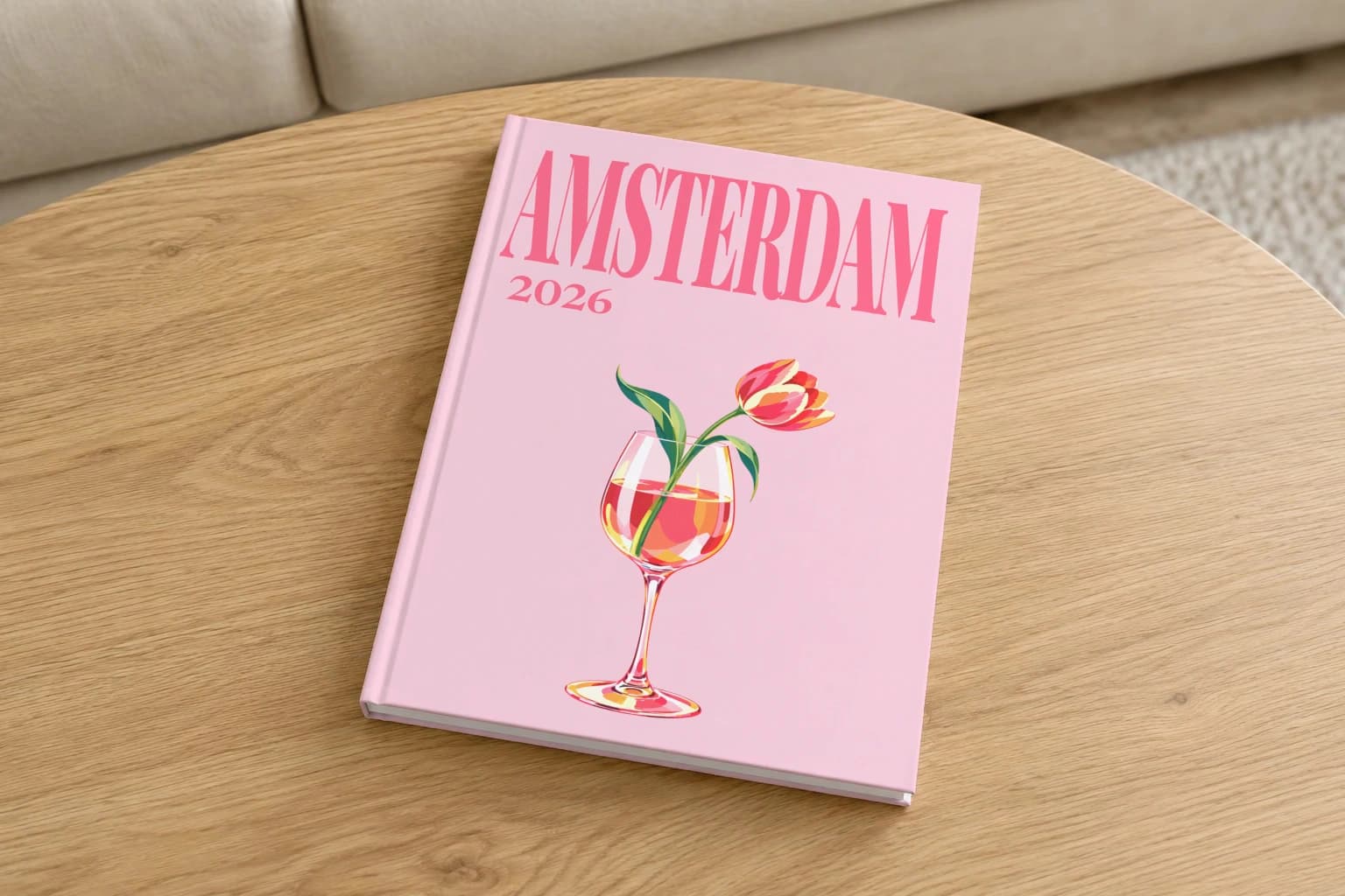 Amsterdam hardcover photo book with the illustrated cover of the tulip in wine glass, on a round oak coffee table in a bright living room