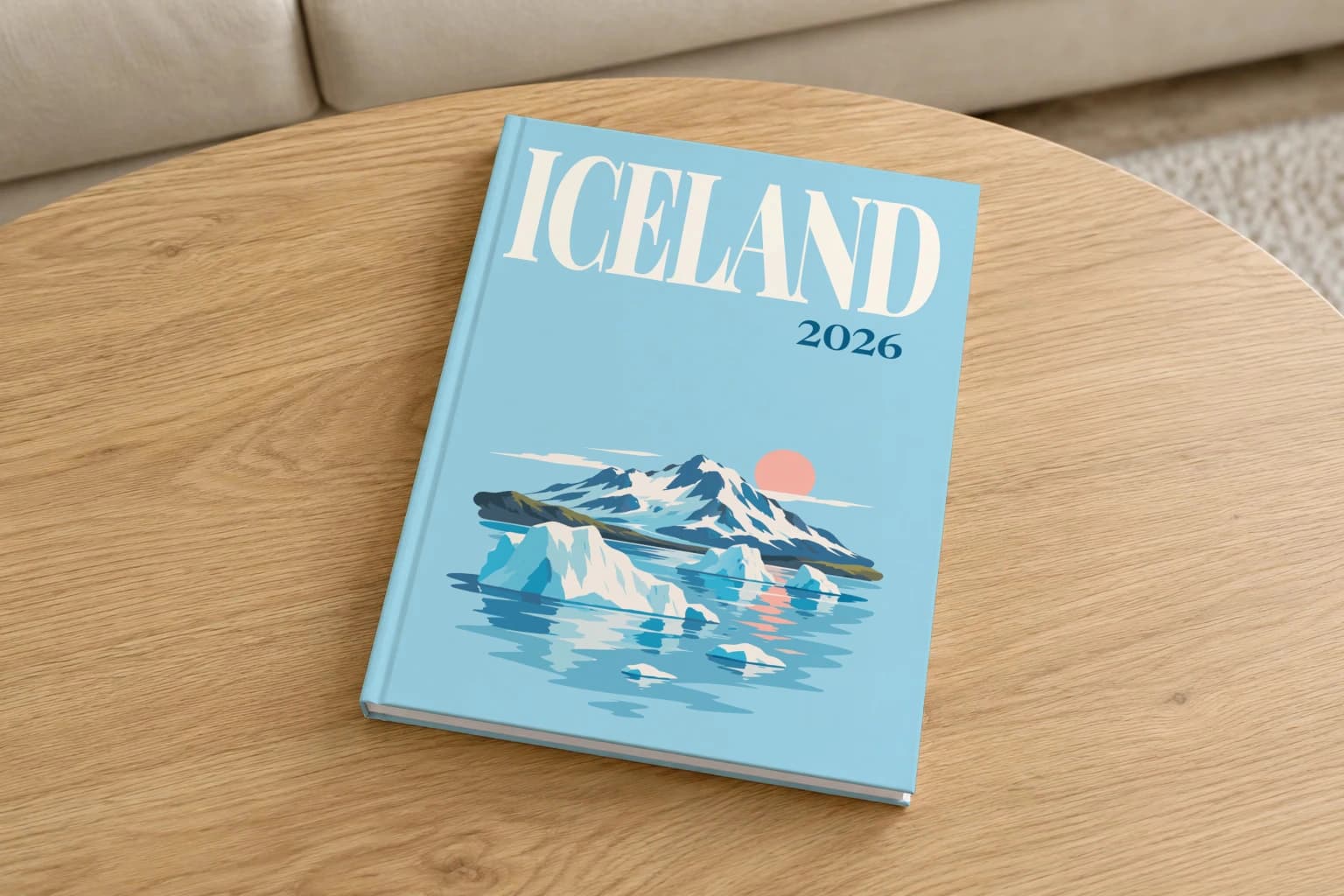 Iceland hardcover photo book with the illustrated cover of the icebergs at sunset, on a round oak coffee table in a bright living room