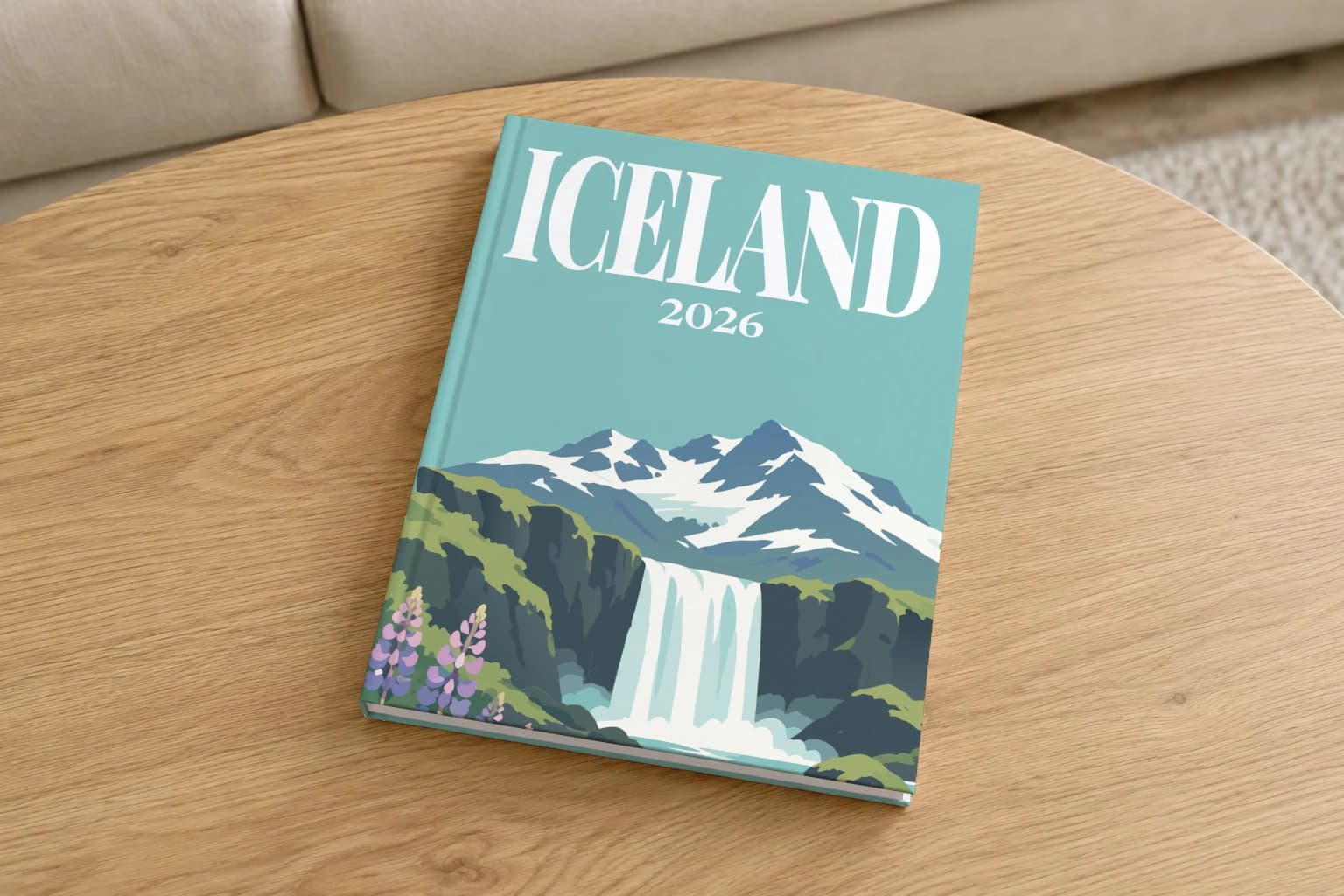 Iceland hardcover photo book with the illustrated cover of the waterfall and lupins, on a round oak coffee table in a bright living room