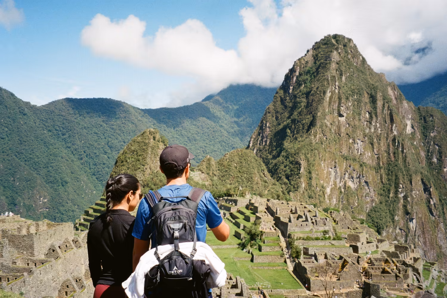 Travellers overlooking Machu Picchu in Peru while sharing family trip photos privately