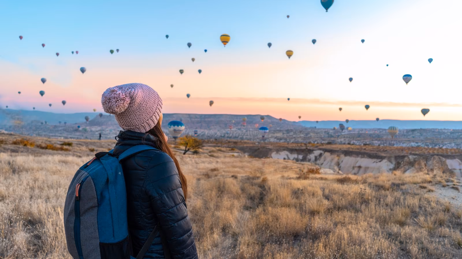 A traveller watching hot-air balloons over Cappadocia