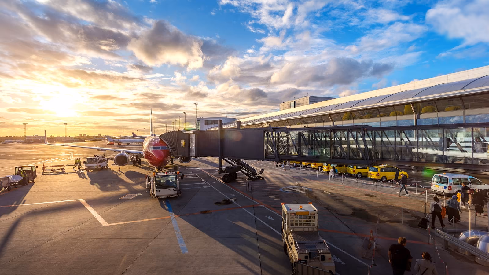 An airport departure gate illuminated by sunset