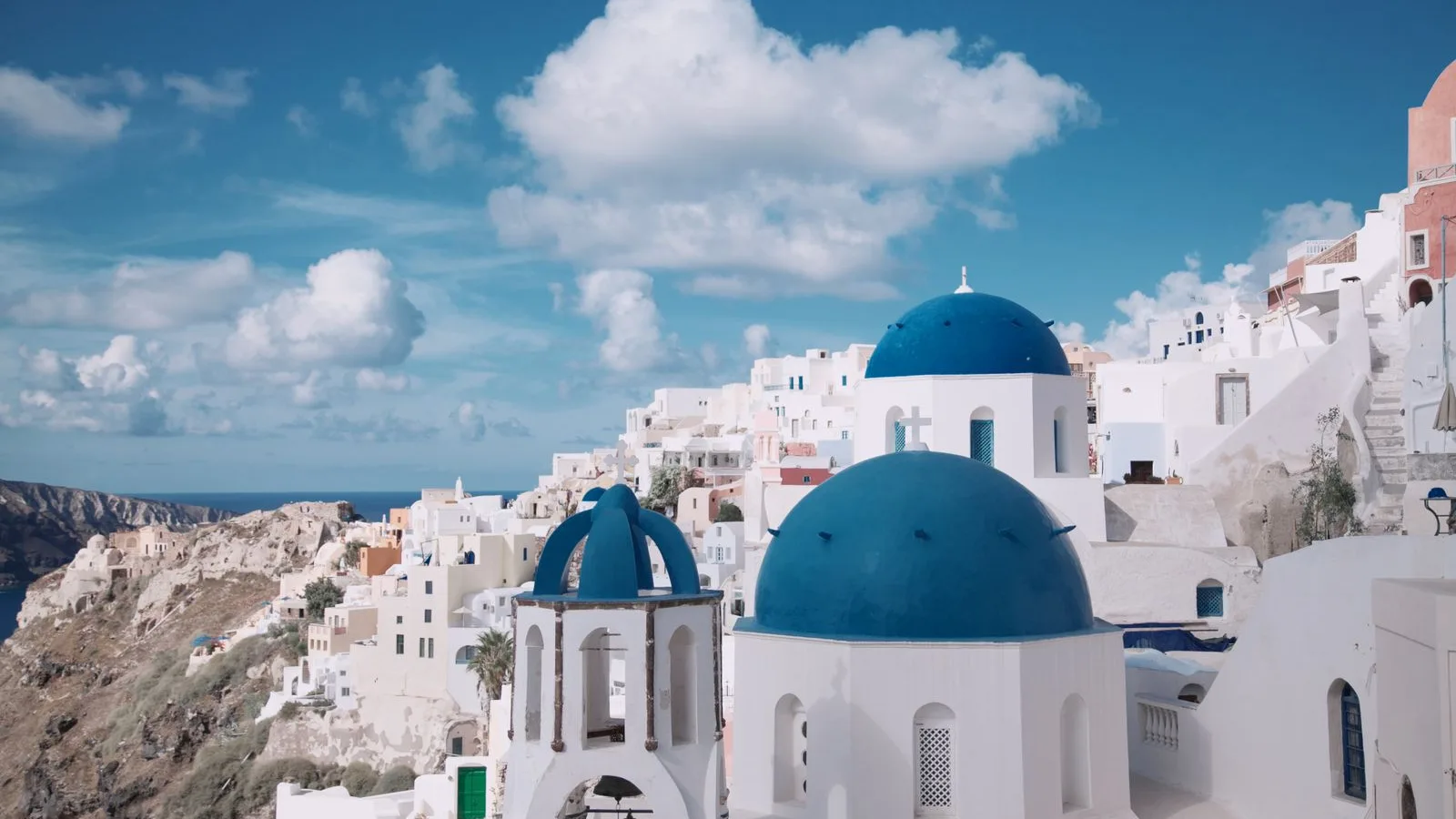 Santorini blue domes and sea illustrating a digital nomad travel journal