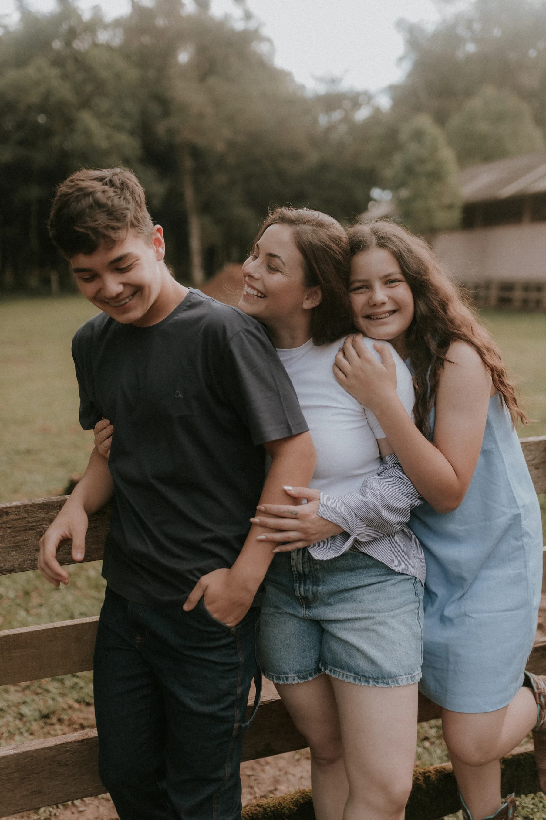 Adult siblings and family members embracing outdoors
