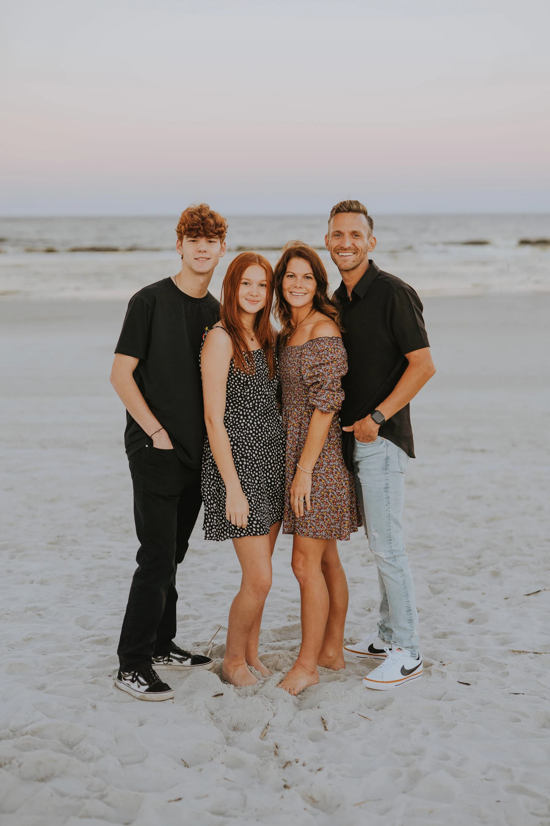 Family with teenagers together on a beach holiday