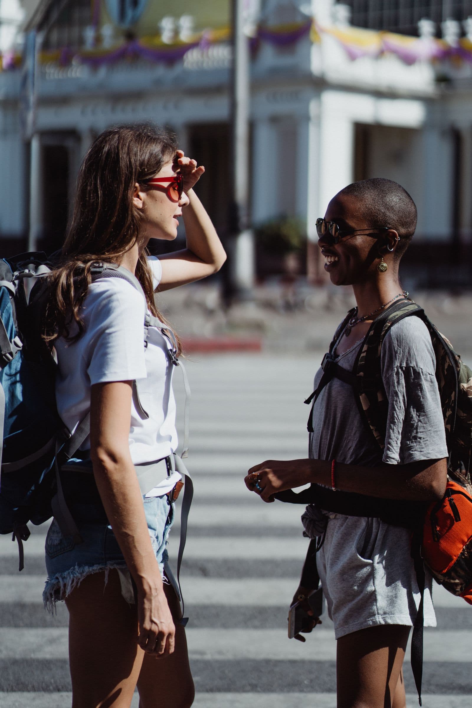 Young gap year travellers exploring a new city with backpacks