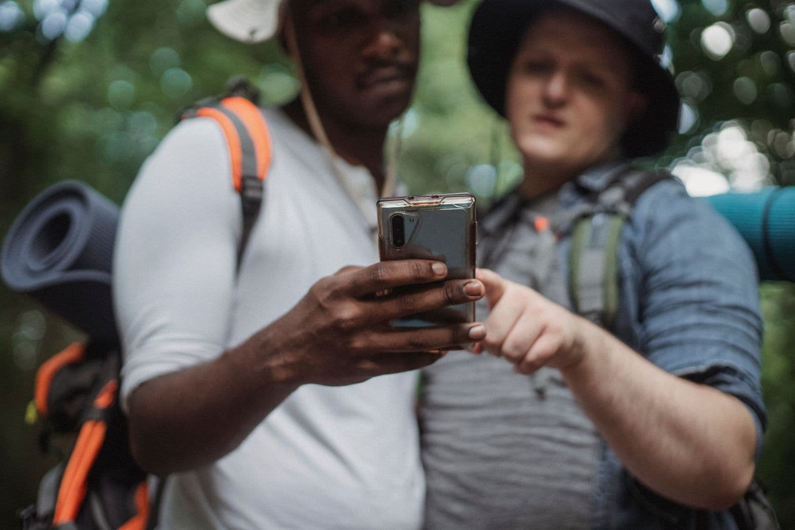 Gap year friends using a travel app together outdoors