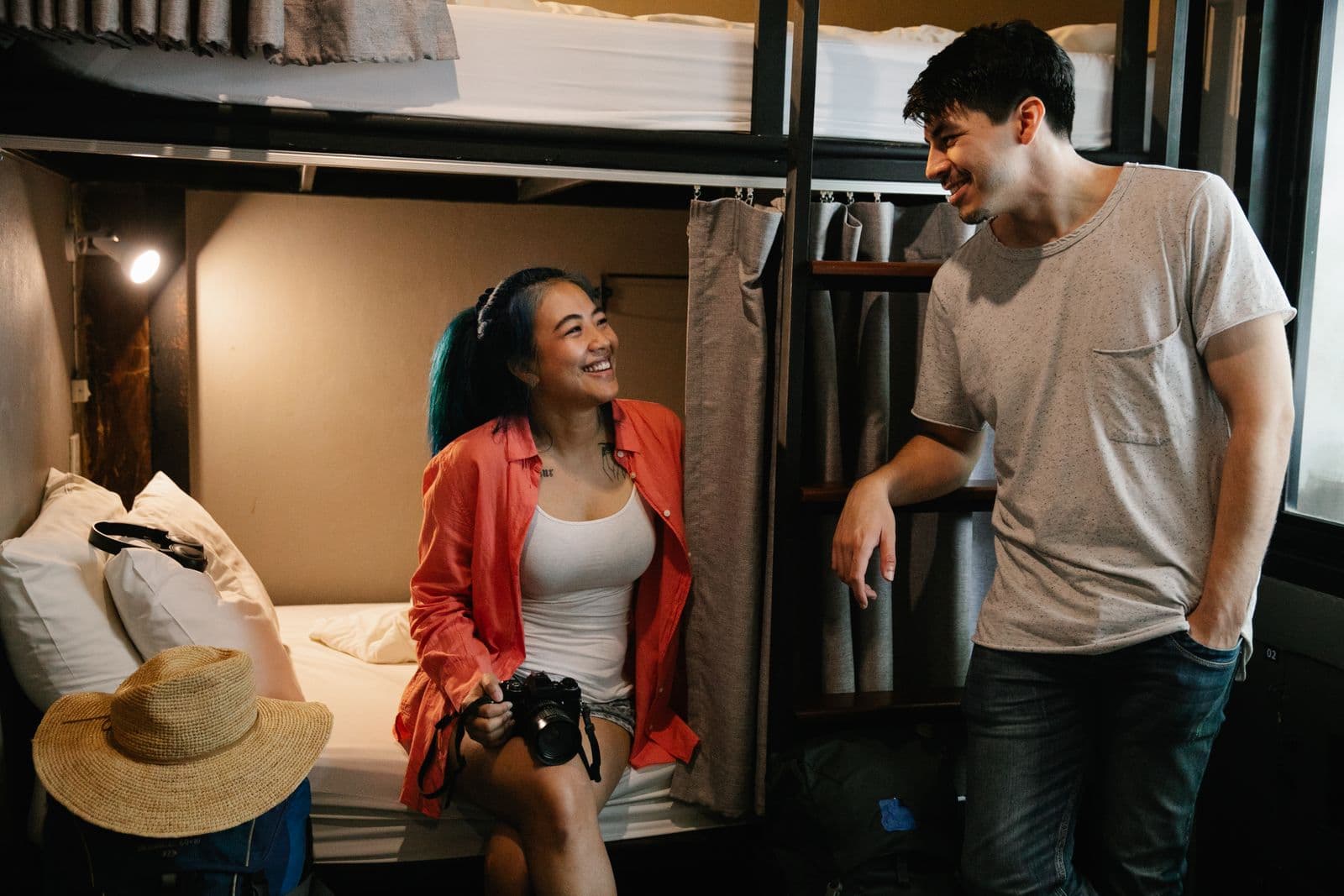 Young travellers capturing photos together in a hostel