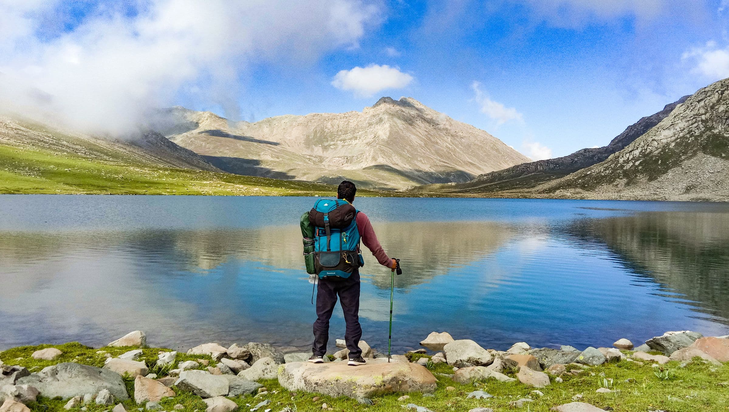 Backpacker beside a mountain lake
