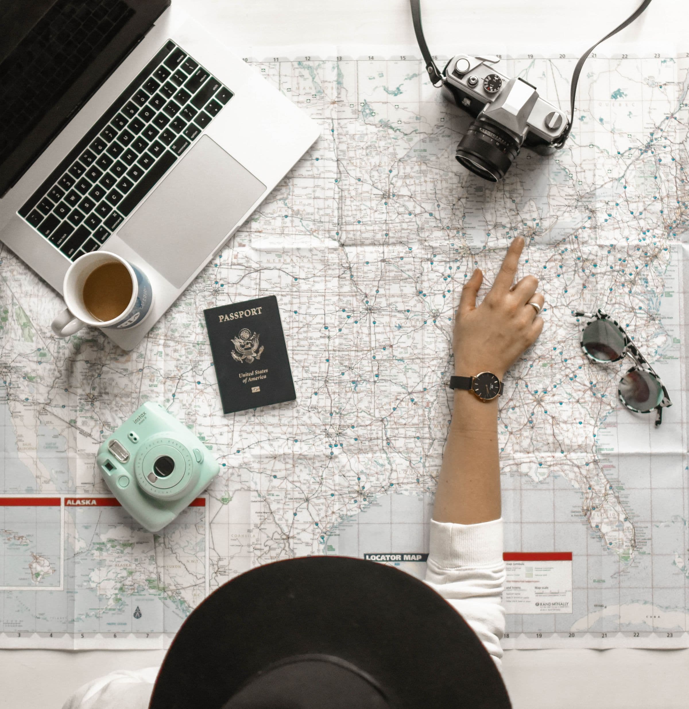 A traveller planning a driving route with a map and camera