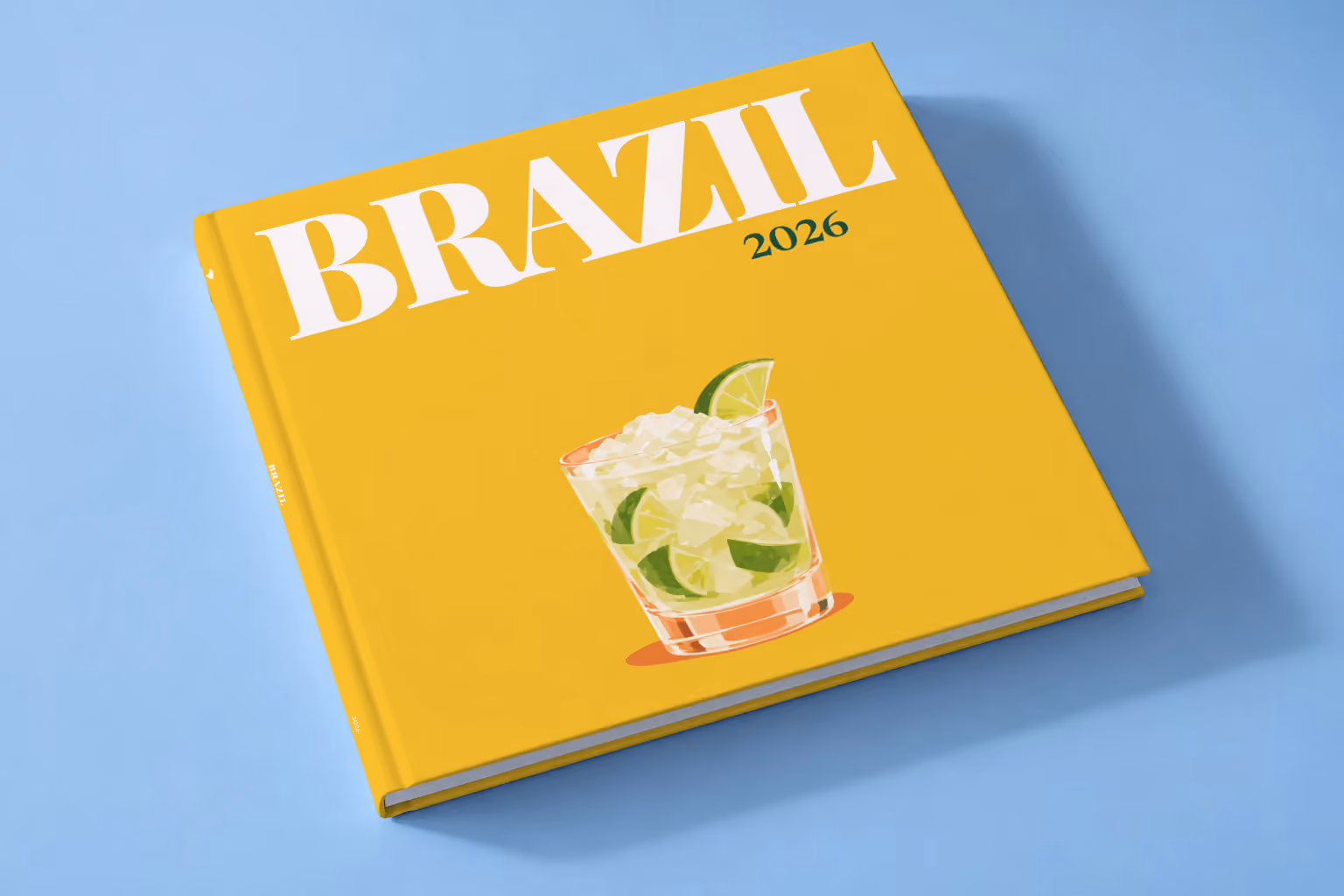 Brazil square hardcover photo book with the illustrated cover of a caipirinha with crushed ice and lime on golden yellow, lying on a pale blue studio backdrop
