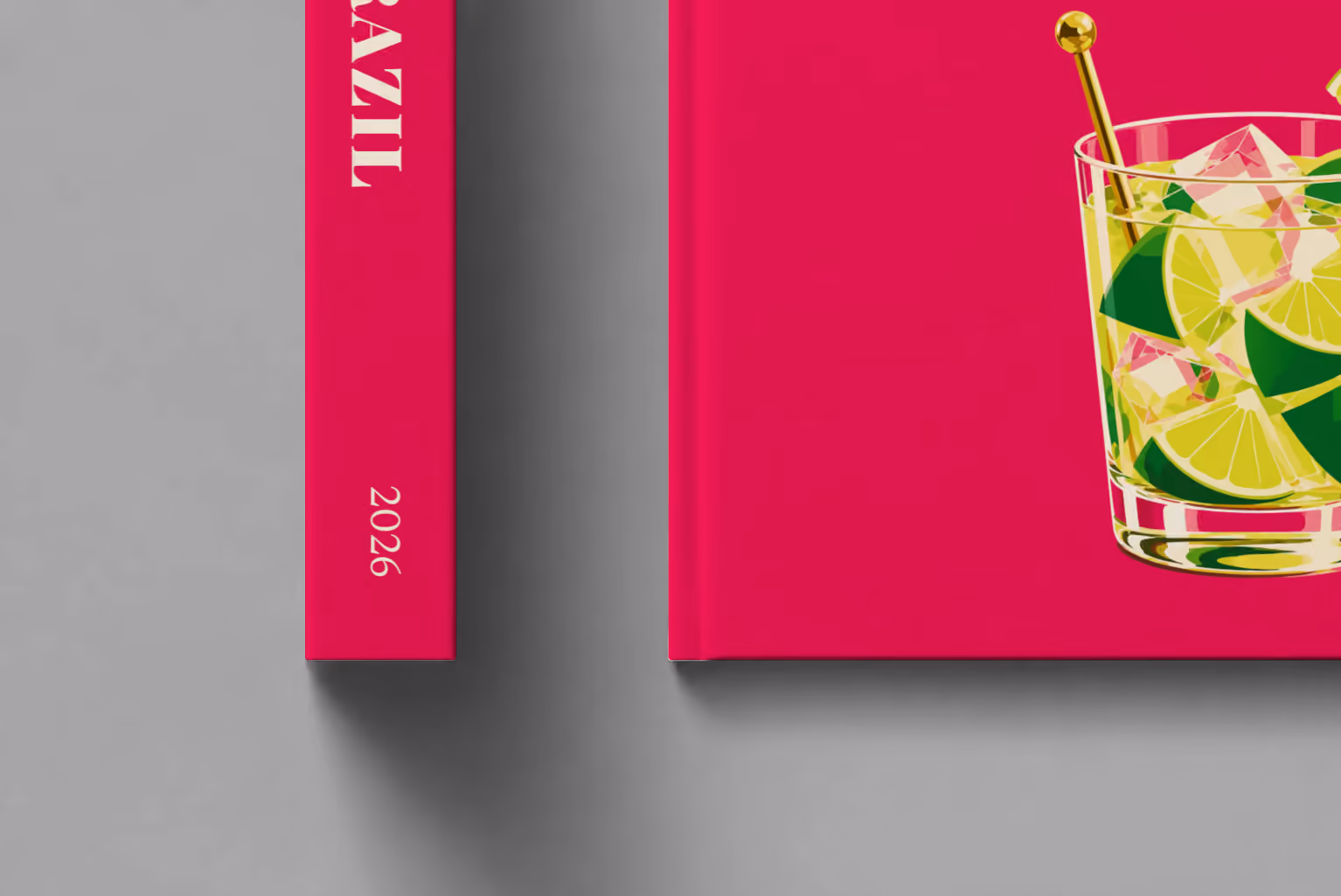 Brazil hardcover photo book with the illustrated cover of a caipirinha with lime wedges on magenta, shown close up beside its spine on a pale grey studio surface