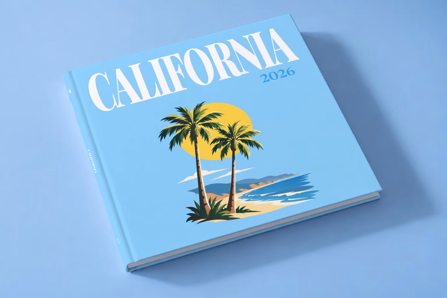 California square hardcover photo book with the illustrated cover of palm trees and a beach under a yellow sun on sky blue, lying on a pale blue studio backdrop
