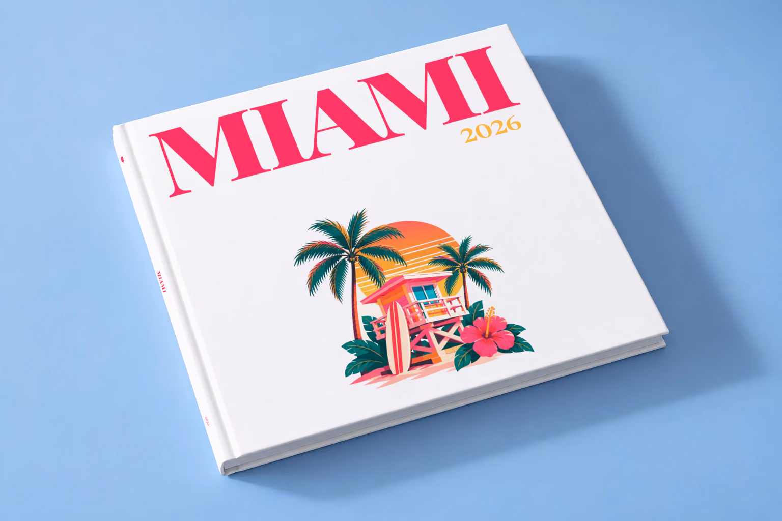 Florida square hardcover photo book with the Miami illustrated cover of a pink Miami Beach lifeguard tower with palm trees at sunset on white, lying on a pale blue studio backdrop