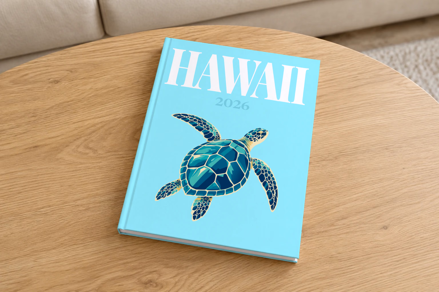 Hawaii hardcover photo book with the illustrated cover of a green sea turtle on pale aqua, on a round oak coffee table in a bright living room