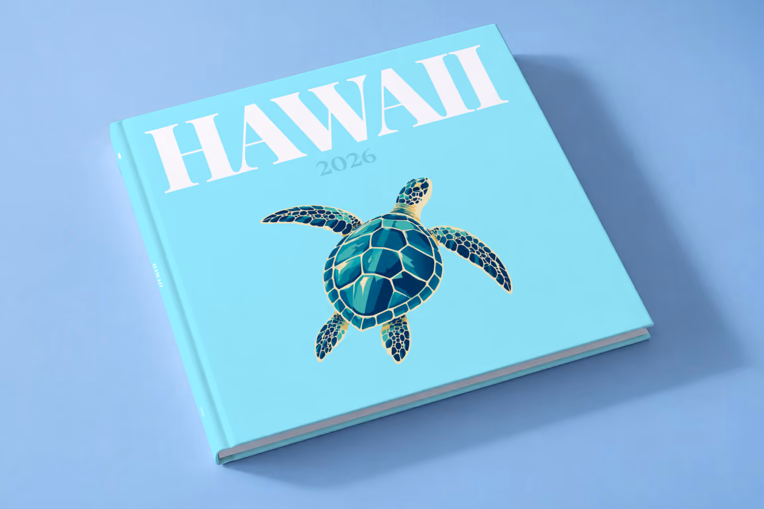 Hawaii square hardcover photo book with the illustrated cover of a green sea turtle on pale aqua, lying on a pale blue studio backdrop