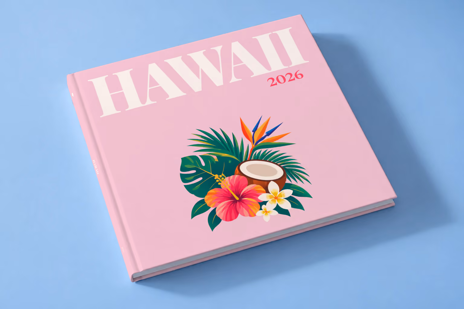 Hawaii square hardcover photo book with the illustrated cover of a tropical bouquet with hibiscus, a coconut and palm leaves on pale pink, lying on a pale blue studio backdrop