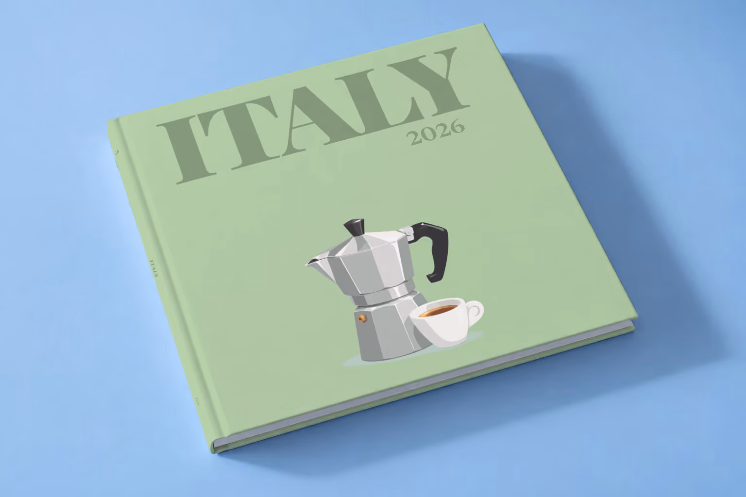 Italy square hardcover photo book with the illustrated cover of a moka pot and an espresso cup on sage green, lying on a pale blue studio backdrop