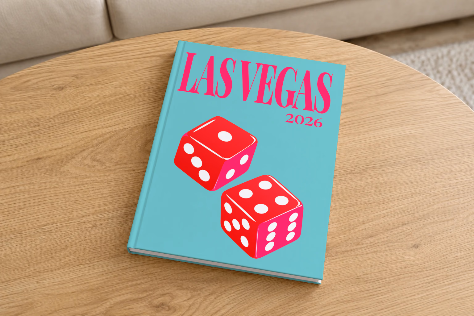 Las Vegas hardcover photo book with the illustrated cover of a pair of red casino dice on turquoise, on a round oak coffee table in a bright living room