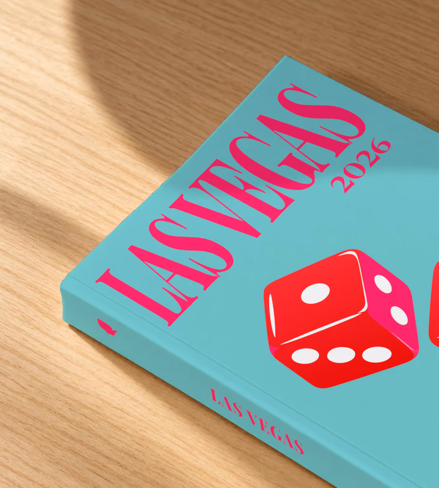 Las Vegas softcover photo book with the illustrated cover of a pair of red casino dice on turquoise, lying on an oak desk in dappled afternoon sunlight