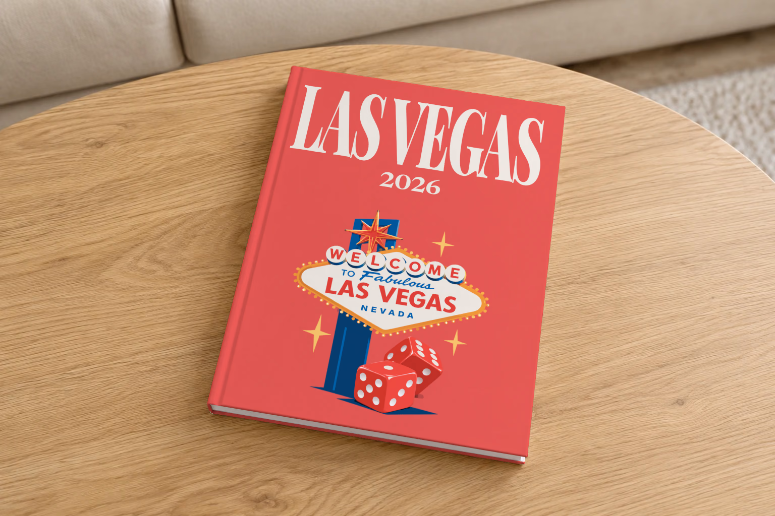 Las Vegas hardcover photo book with the illustrated cover of the Welcome to Fabulous Las Vegas sign and red dice on red, on a round oak coffee table in a bright living room