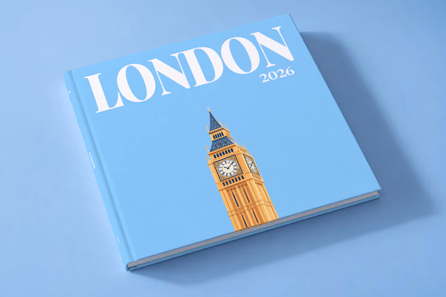 London square hardcover photo book with the illustrated cover of Big Ben's Elizabeth Tower on sky blue, lying on a pale blue studio backdrop