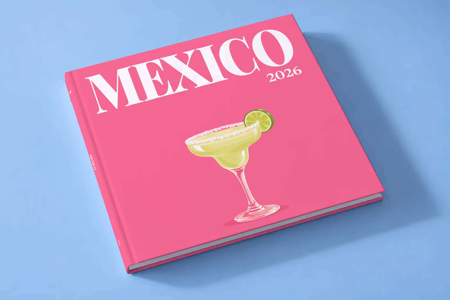 Mexico square hardcover photo book with the illustrated cover of a margarita with lime on hot pink, lying on a pale blue studio backdrop