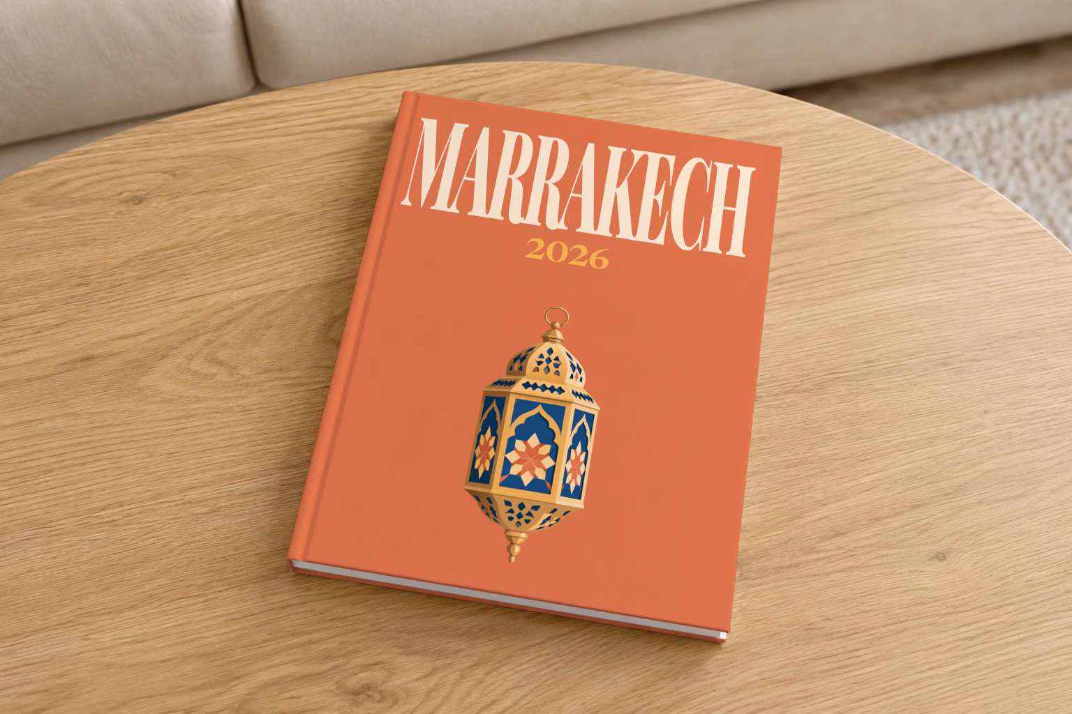 Morocco hardcover photo book with the Marrakech illustrated cover of a gold and blue Moroccan lantern on terracotta, on a round oak coffee table in a bright living room
