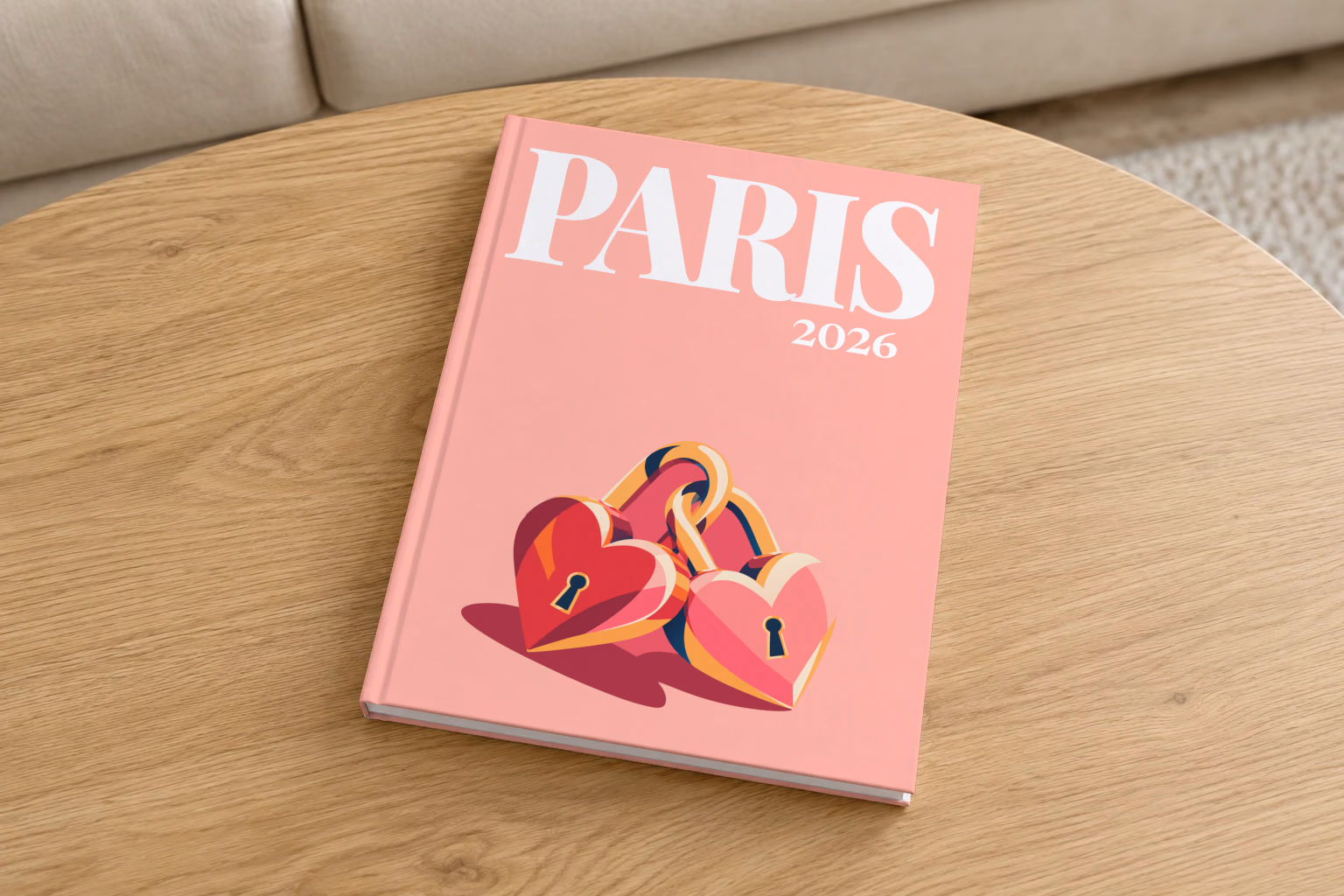 Paris hardcover photo book with the illustrated cover of heart-shaped love locks on salmon pink, on a round oak coffee table in a bright living room
