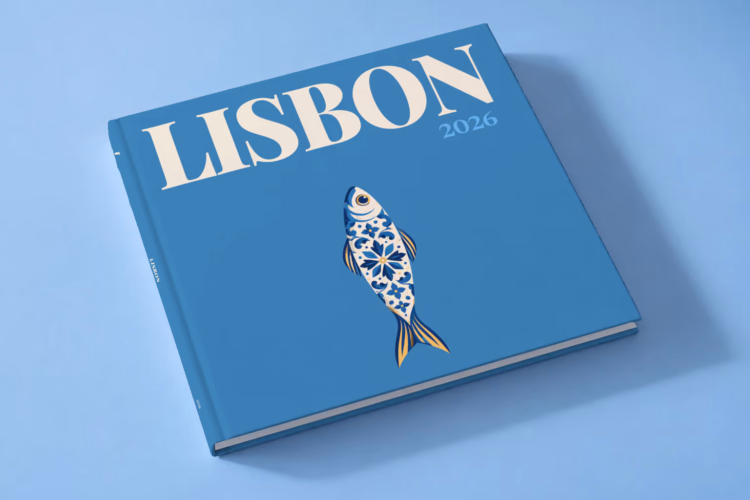Portugal square hardcover photo book with the Lisbon illustrated cover of a blue and white azulejo-tiled sardine on denim blue, lying on a pale blue studio backdrop