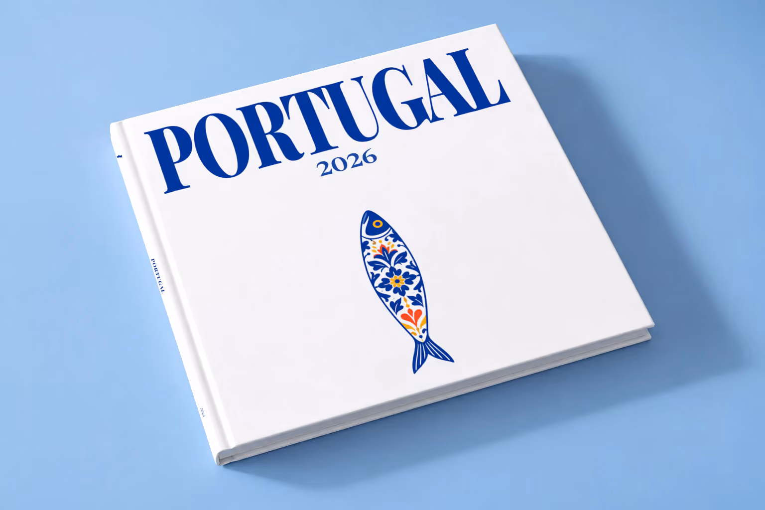 Portugal square hardcover photo book with the illustrated cover of a blue and white azulejo-tiled Portuguese sardine on white, lying on a pale blue studio backdrop