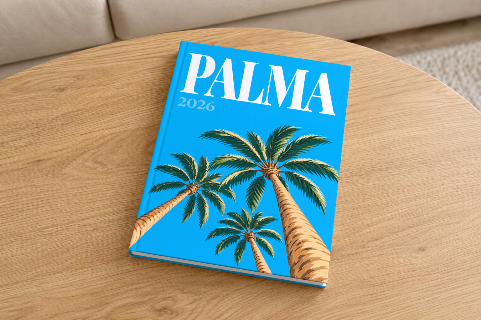 Spain hardcover photo book with the Palma illustrated cover of palm trees on bright blue, on a round oak coffee table in a bright living room