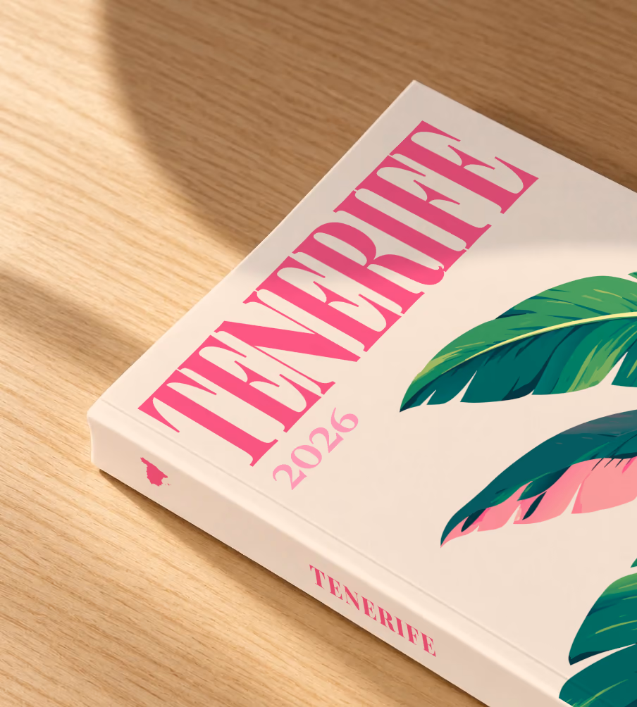 Spain softcover photo book with the Tenerife illustrated cover of banana leaves on cream, lying on an oak desk in dappled afternoon sunlight