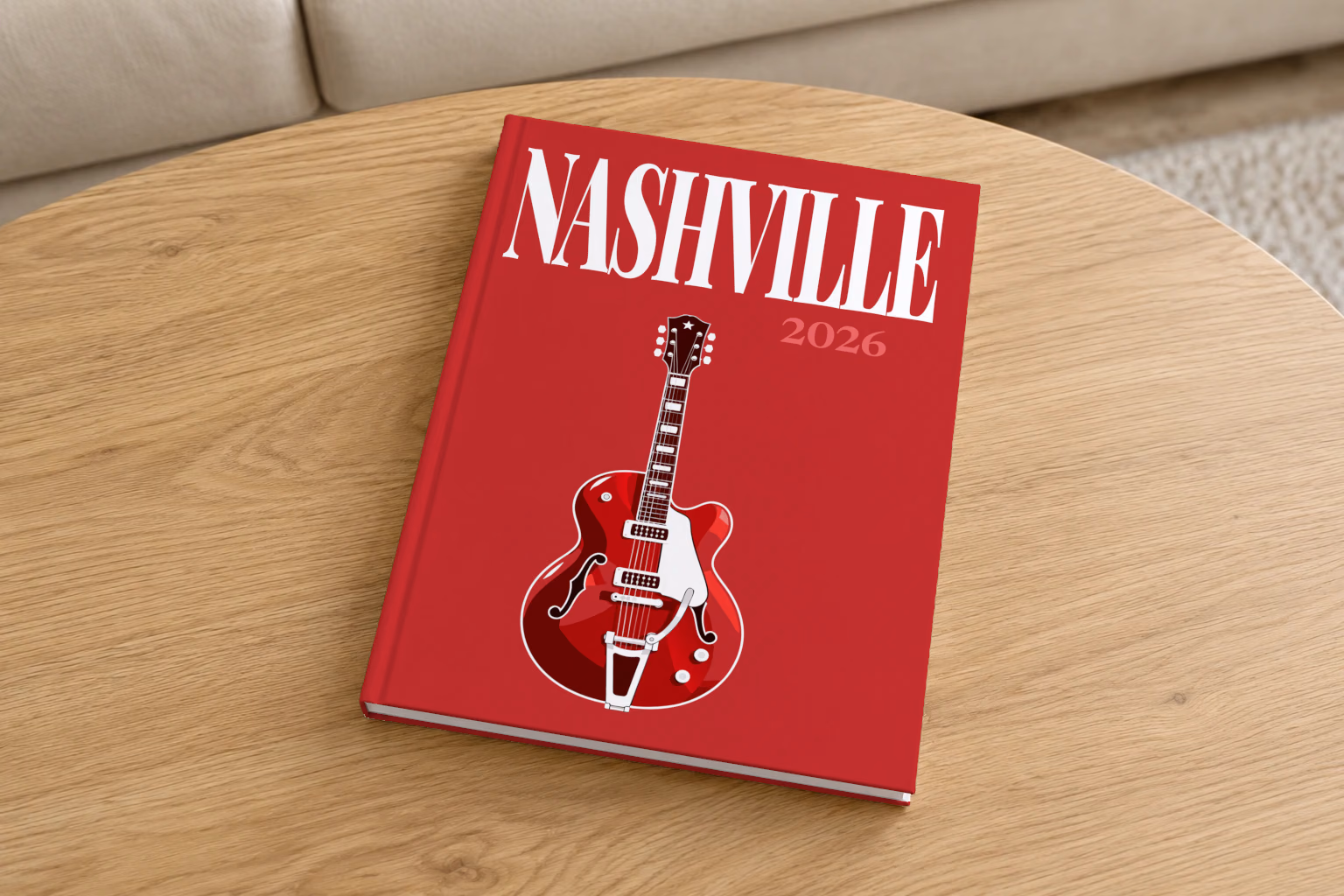 Tennessee hardcover photo book with the Nashville illustrated cover of a red electric guitar on crimson, on a round oak coffee table in a bright living room