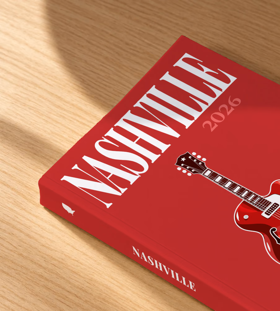Tennessee softcover photo book with the Nashville illustrated cover of a red electric guitar on crimson, lying on an oak desk in dappled afternoon sunlight