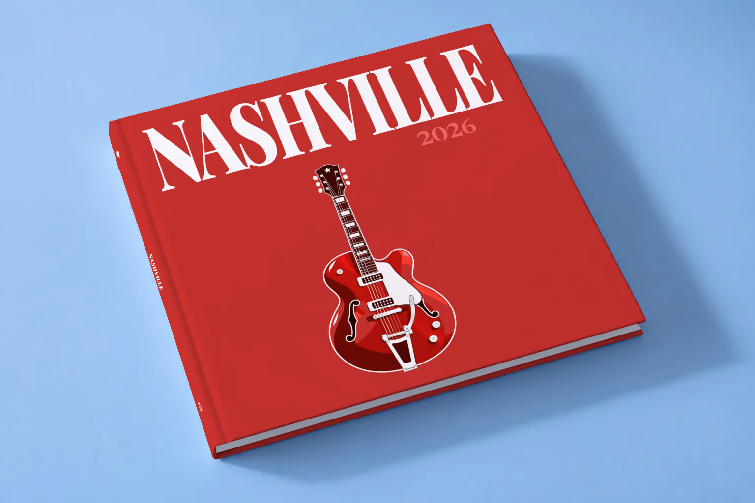 Tennessee square hardcover photo book with the Nashville illustrated cover of a red electric guitar on crimson, lying on a pale blue studio backdrop