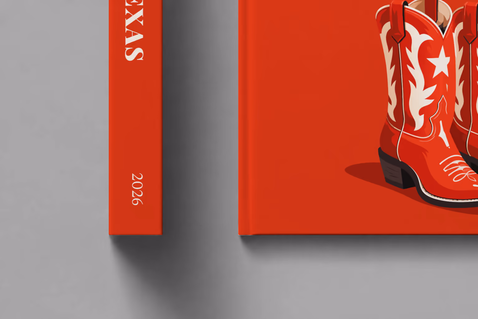 Texas hardcover photo book with the illustrated cover of a pair of red cowboy boots with white stars on red, shown close up beside its spine on a pale grey studio surface