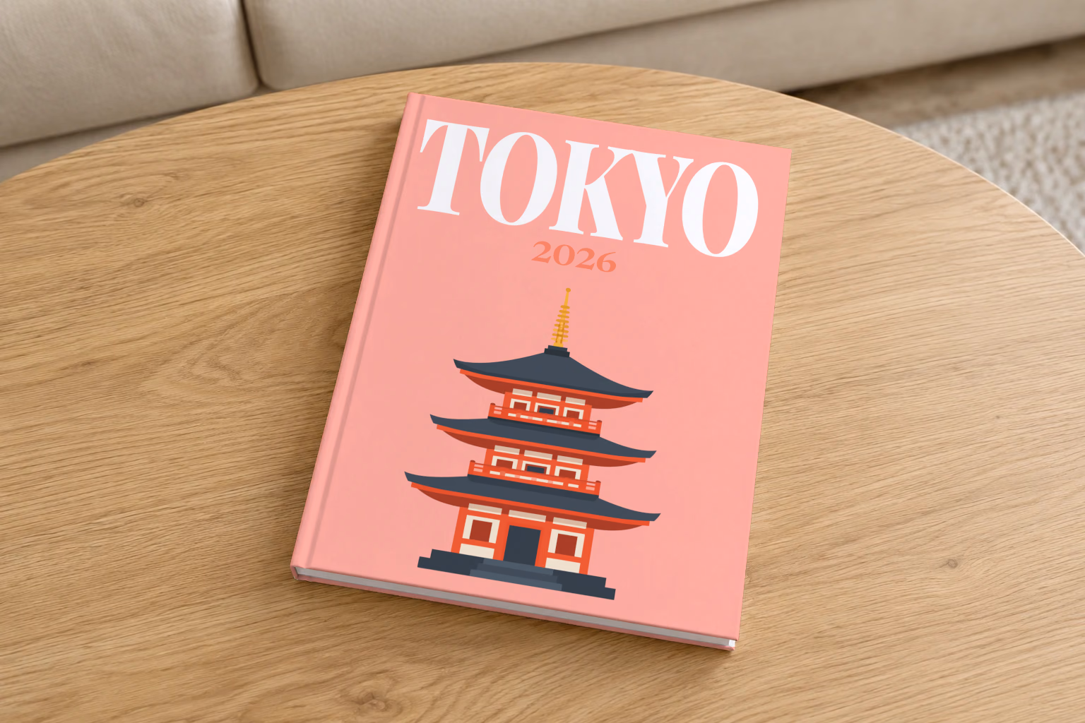 Tokyo hardcover photo book with the illustrated cover of a pagoda on salmon pink, on a round oak coffee table in a bright living room