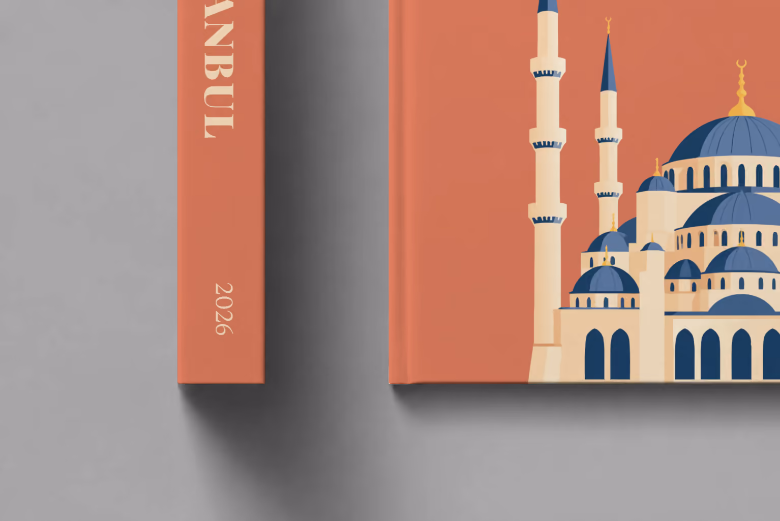 Turkey hardcover photo book with the Istanbul illustrated cover of the domes and minarets of the Blue Mosque on terracotta, shown close up beside its spine on a pale grey studio surface