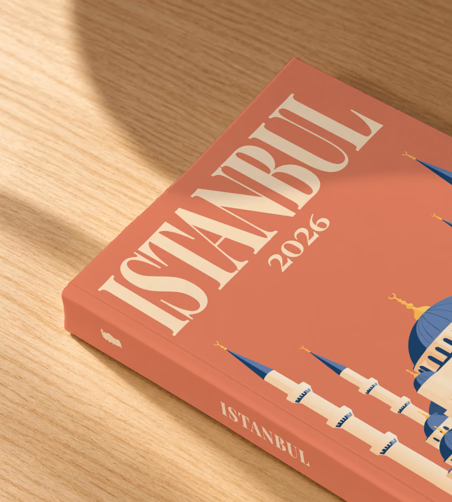 Turkey softcover photo book with the Istanbul illustrated cover of the domes and minarets of the Blue Mosque on terracotta, lying on an oak desk in dappled afternoon sunlight