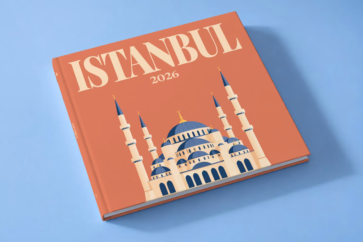 Turkey square hardcover photo book with the Istanbul illustrated cover of the domes and minarets of the Blue Mosque on terracotta, lying on a pale blue studio backdrop