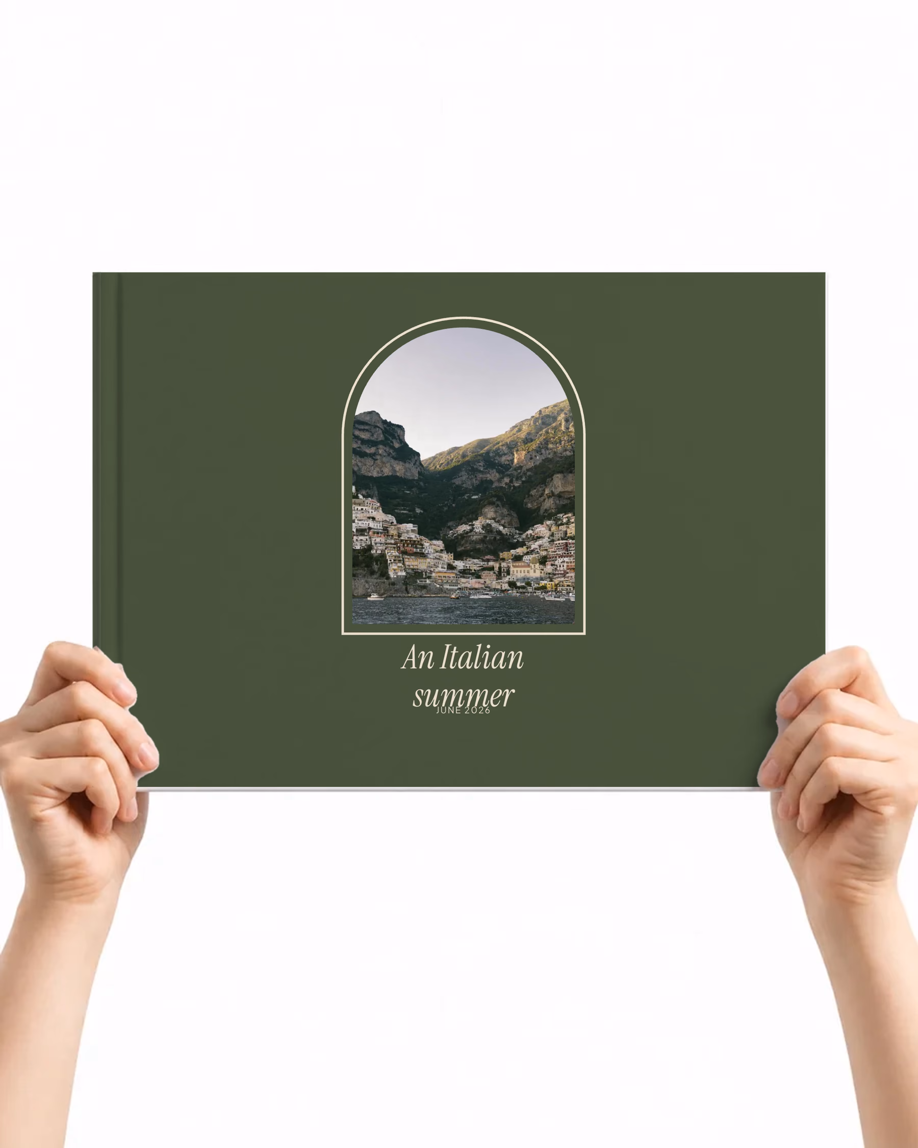 Landscape layflat photo book with the Arch cover, a photo of a cliffside coastal town framed in an arch on dark green above the title An Italian summer, held up in two hands