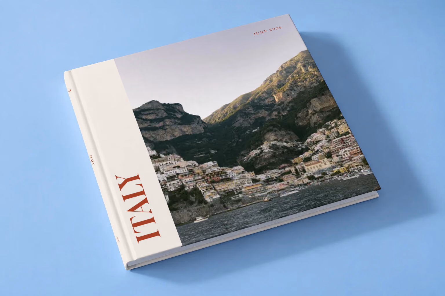 Italy hardcover photo book with the Editorial cover, lying on a pale blue studio backdrop