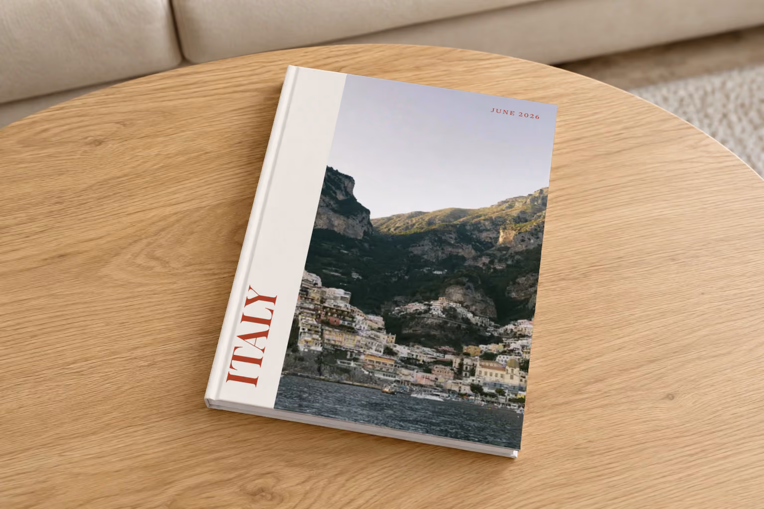 Italy hardcover photo book with the Editorial cover, on a round oak coffee table in a bright living room